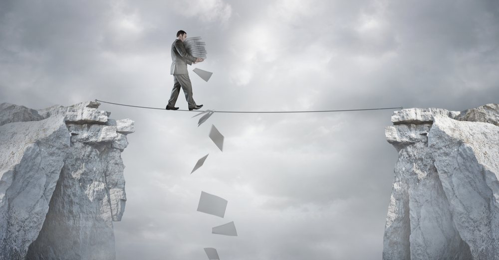 A man balancing a stack of bills